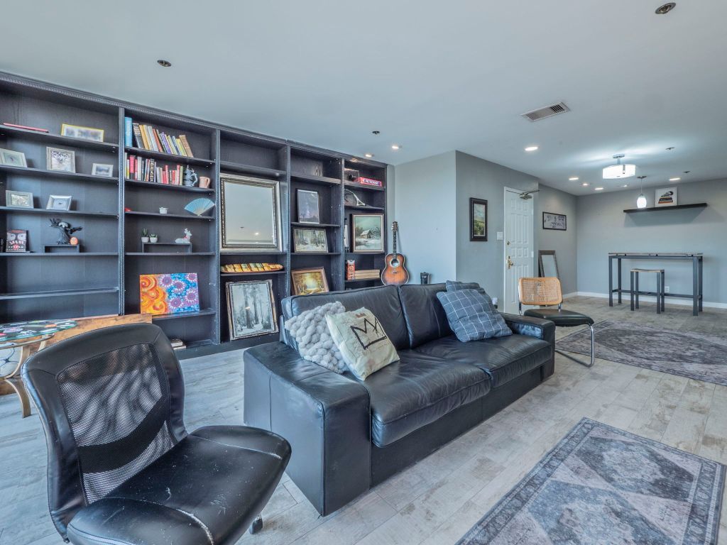 40 North Interstate Highway 35, Unit 4A4 Austin, TX 78701 - Photo 2 of 40 a living room with furniture and a bookshelf