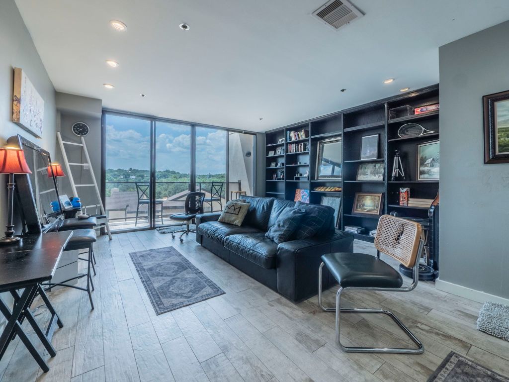 40 North Interstate Highway 35, Unit 4A4 Austin, TX 78701 - Photo 4 of 40 a living room with furniture a rug and a flat screen tv