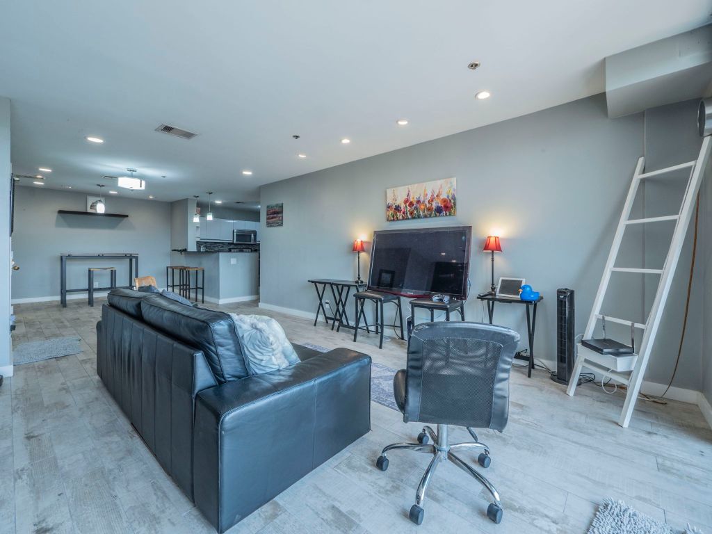 40 North Interstate Highway 35, Unit 4A4 Austin, TX 78701 - Photo 5 of 40 a living room with furniture and a flat screen tv