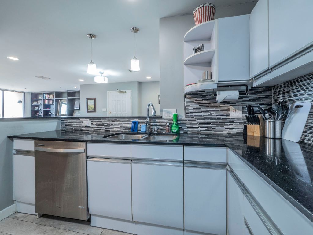 40 North Interstate Highway 35, Unit 4A4 Austin, TX 78701 - Photo 7 of 40 a kitchen with kitchen island white cabinets and counter space