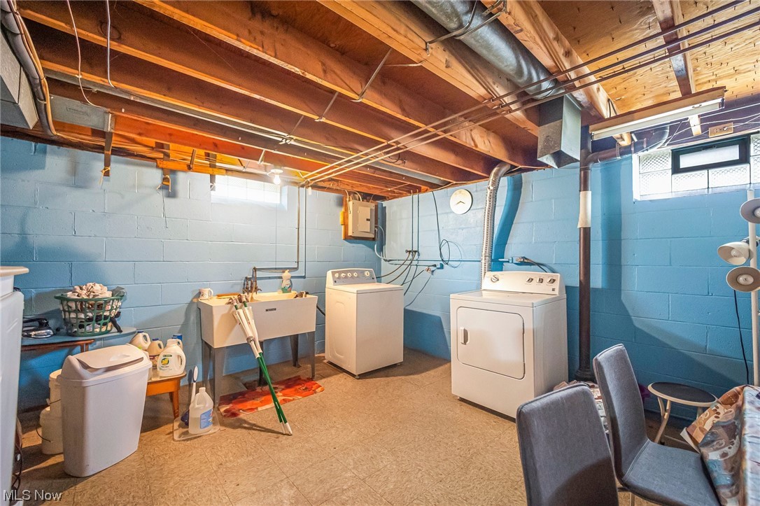 4558 Effie Road Cleveland, OH 44105 - Photo 27 of 30 Basement with light tile floors, separate washer and dryer, and sink
