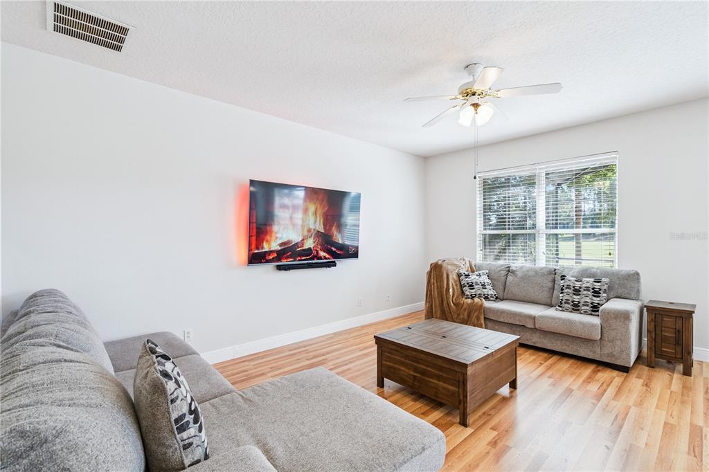 3823 Beacon Ridge Way Clermont, FL 34711 - Photo 11 of 57 a living room with furniture and a flat screen tv