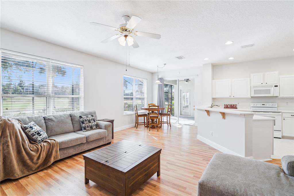 3823 Beacon Ridge Way Clermont, FL 34711 - Photo 12 of 57 a living room with furniture and wooden floor