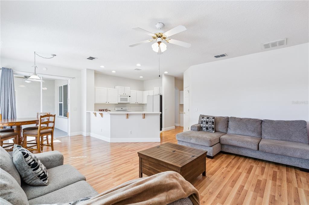 3823 Beacon Ridge Way Clermont, FL 34711 - Photo 13 of 57 a living room with furniture and kitchen view