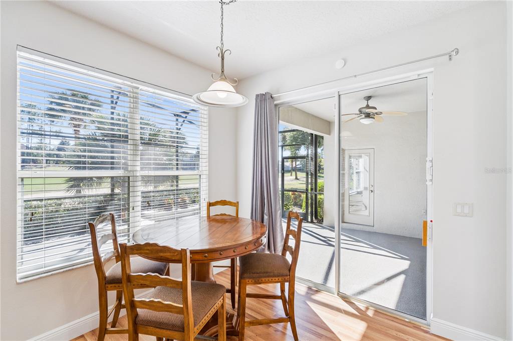 3823 Beacon Ridge Way Clermont, FL 34711 - Photo 15 of 57 a dining room with furniture a chandelier and wooden floor