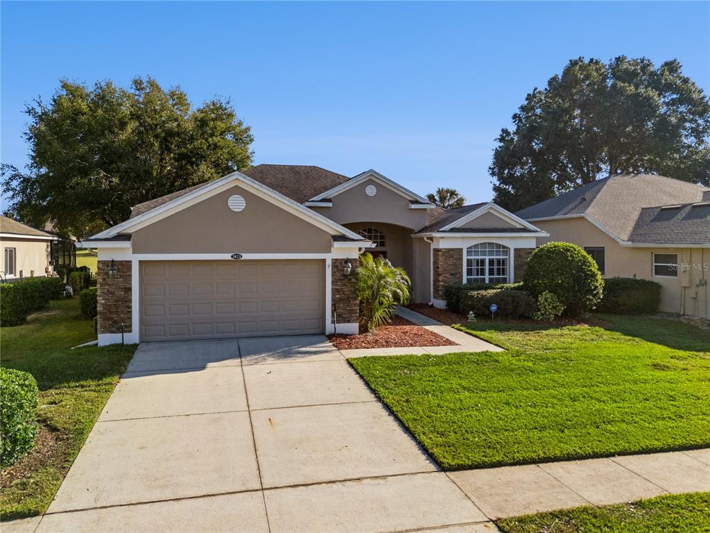 3823 Beacon Ridge Way Clermont, FL 34711 - Photo 2 of 57 a front view of a house with a yard