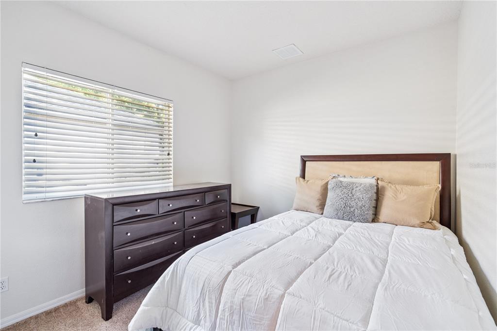 3823 Beacon Ridge Way Clermont, FL 34711 - Photo 25 of 57 a bedroom with a bed and a window