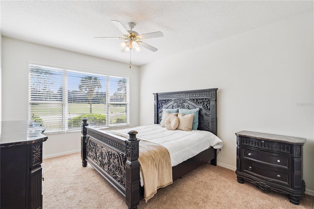 3823 Beacon Ridge Way Clermont, FL 34711 - Photo 28 of 57 a bedroom with a bed and a chandelier