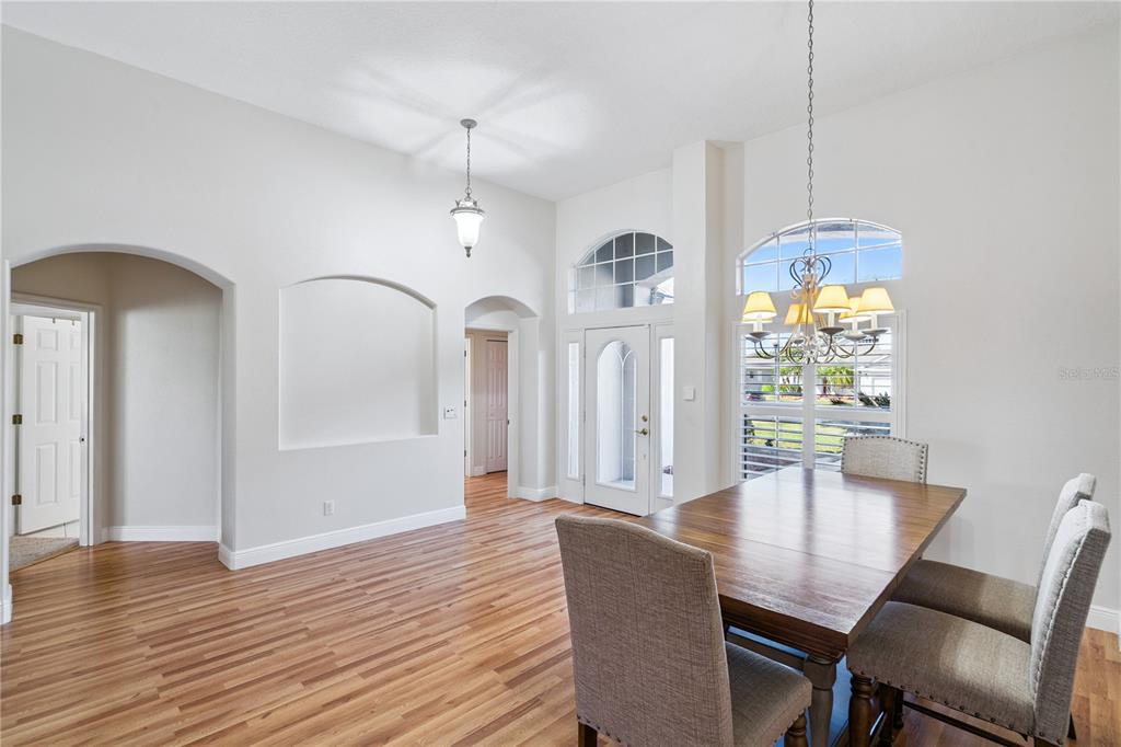 3823 Beacon Ridge Way Clermont, FL 34711 - Photo 3 of 57 a view of a dining room with furniture window and wooden floor