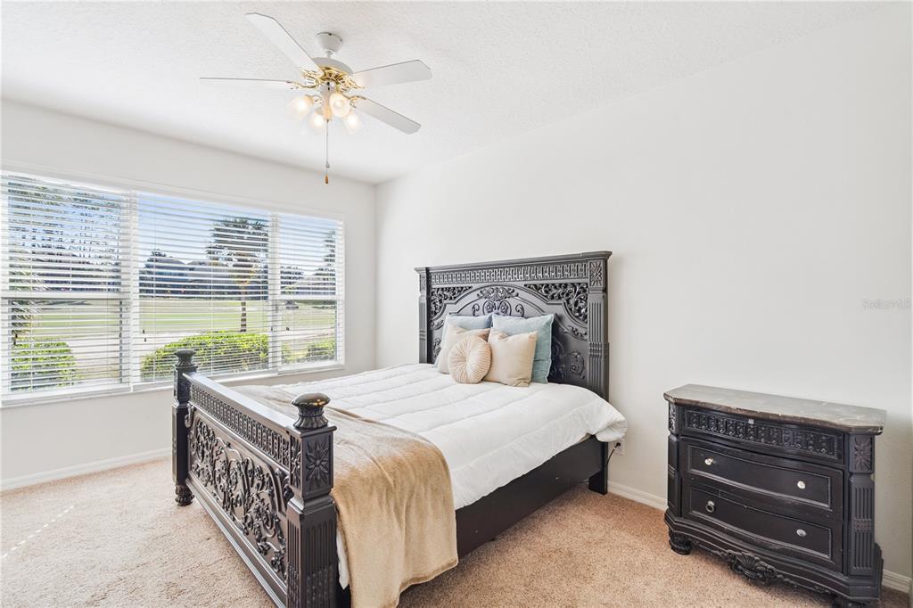 3823 Beacon Ridge Way Clermont, FL 34711 - Photo 32 of 57 a bedroom with a bed and a chandelier