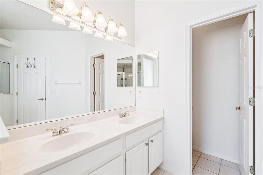 3823 Beacon Ridge Way Clermont, FL 34711 - Photo 33 of 57 a bathroom with a sink vanity and a mirror