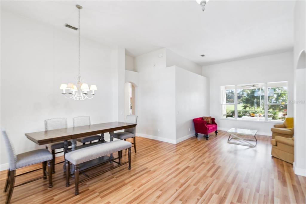 3823 Beacon Ridge Way Clermont, FL 34711 - Photo 5 of 57 a living room with furniture and a wooden floor