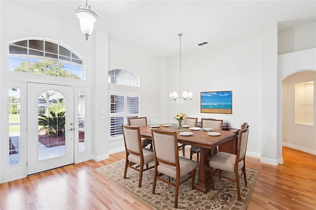 3823 Beacon Ridge Way Clermont, FL 34711 - Photo 6 of 57 a view of a dining room with furniture wooden floor and chandelier