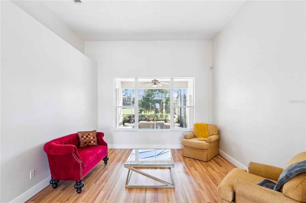 3823 Beacon Ridge Way Clermont, FL 34711 - Photo 9 of 57 a living room with furniture and a large window