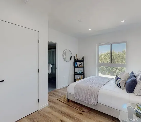 a bedroom with a large bed and a window
