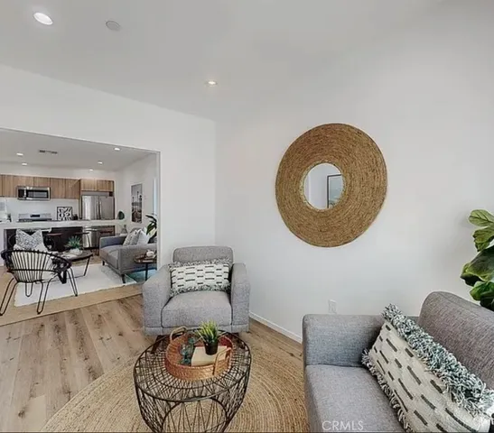 a living room with furniture a rug and a window