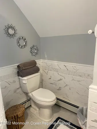 a white toilet sitting next to a bathroom sink