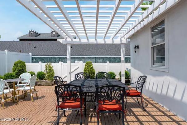 a view of an outside dining space with furniture