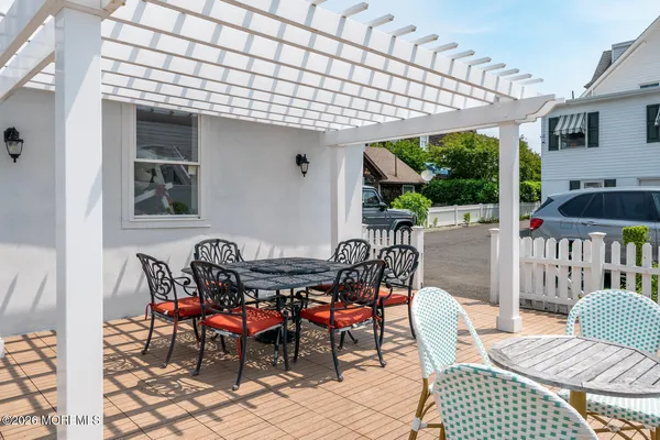 a view of a patio with table and chairs