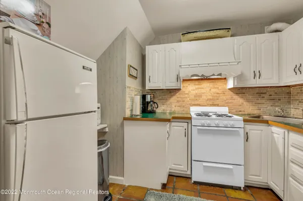 a kitchen with stainless steel appliances a refrigerator and a stove