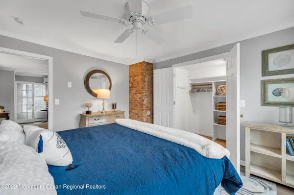 a spacious bedroom with a bed and a dresser