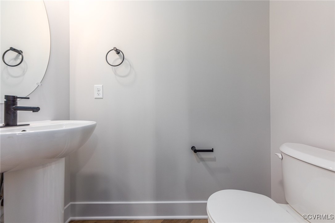 4801 Partlow Road Partlow, VA 22534 - Photo 11 of 30 Bathroom featuring sink, toilet, and hardwood / wo