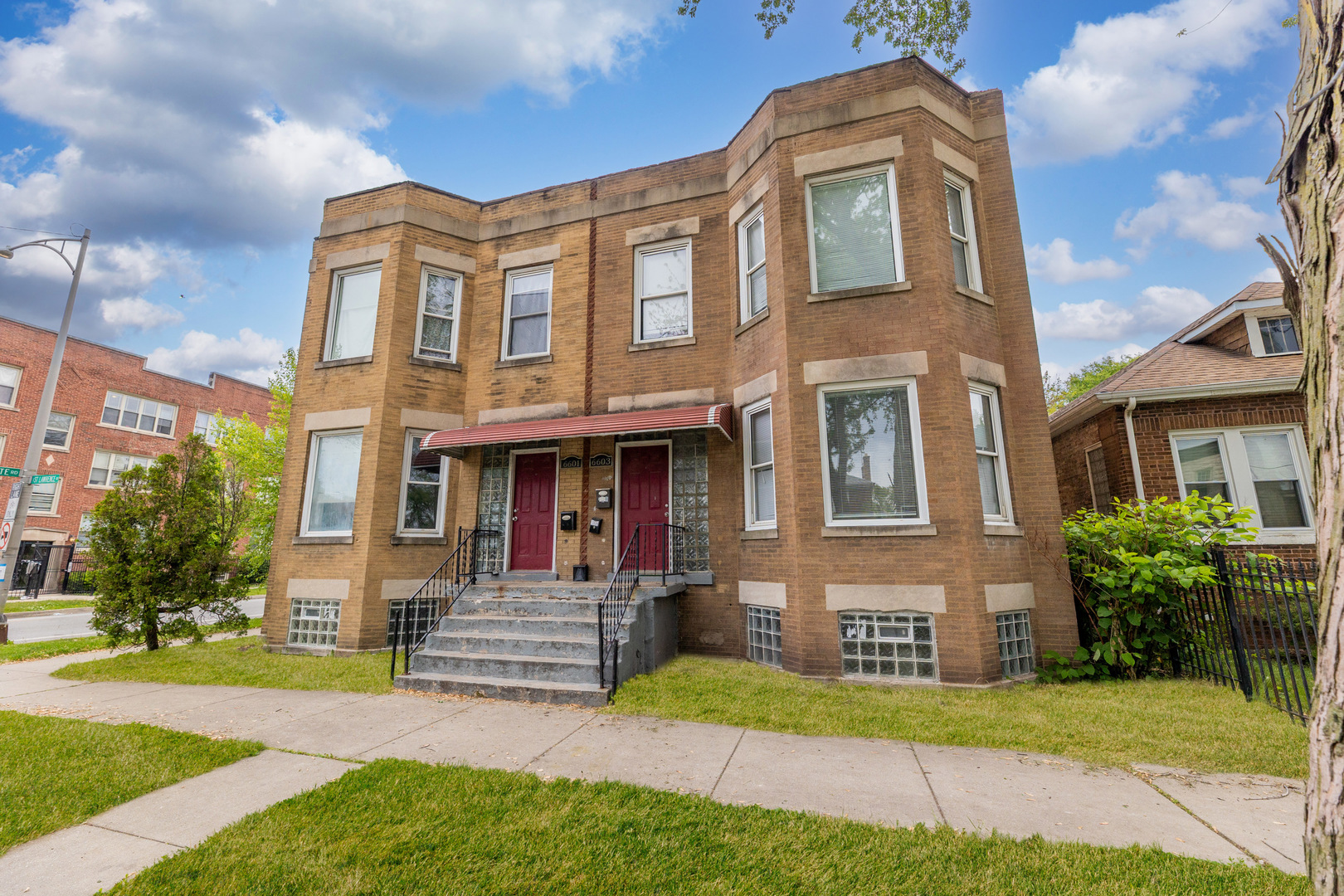 6601 South St Lawrence Avenue Chicago, IL 60637 - Photo 20 of 29 a front view of a house with yard and green space