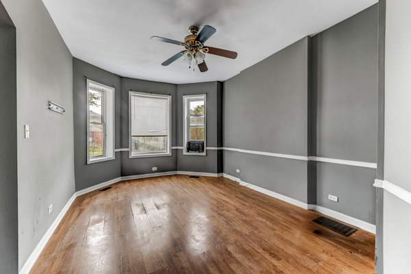 6601 South St Lawrence Avenue Chicago, IL 60637 - Photo 2 of 29 a view of an empty room with a window and wooden floor