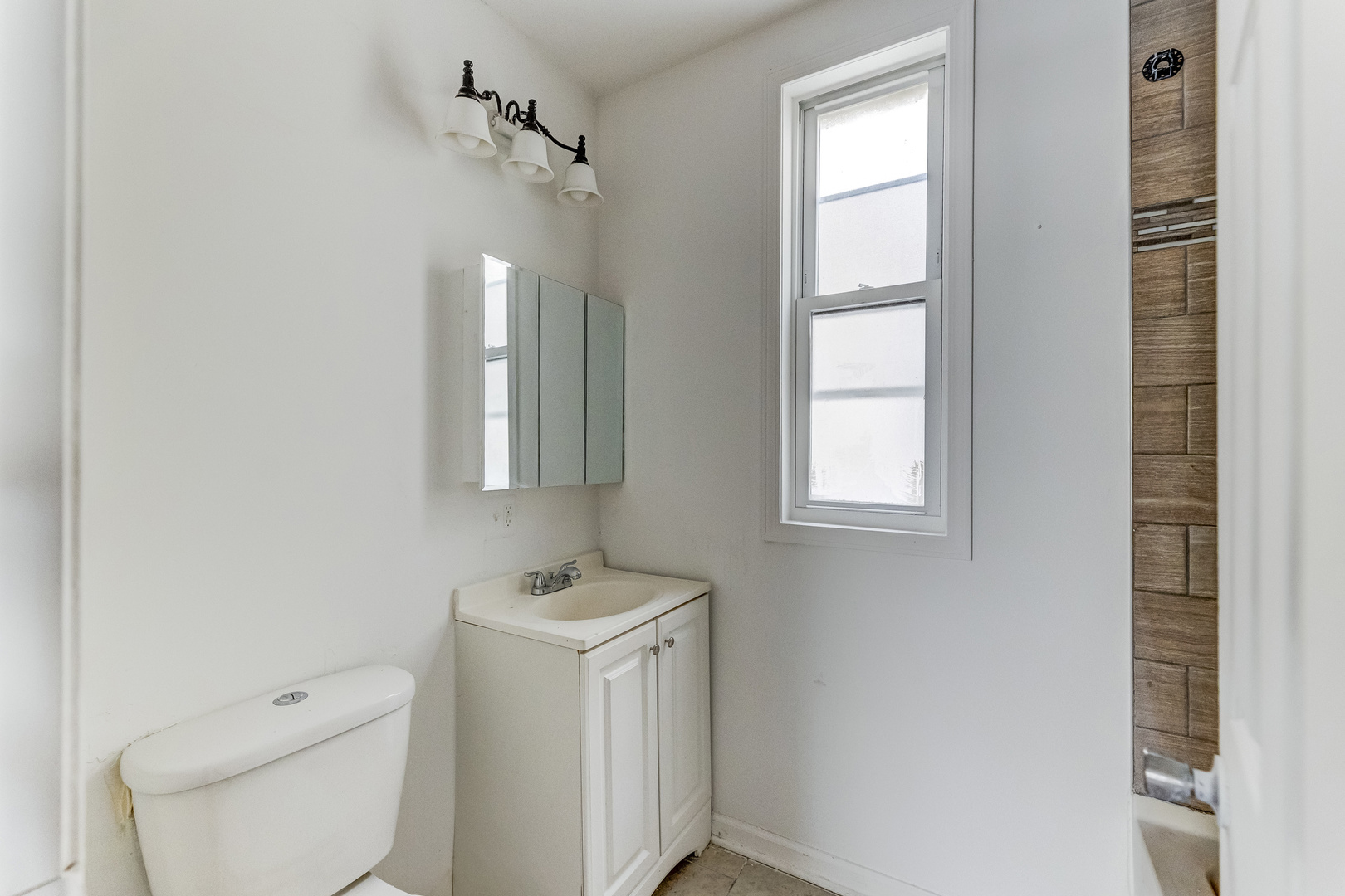 6601 South St Lawrence Avenue Chicago, IL 60637 - Photo 5 of 29 a bathroom with a toilet sink and mirror