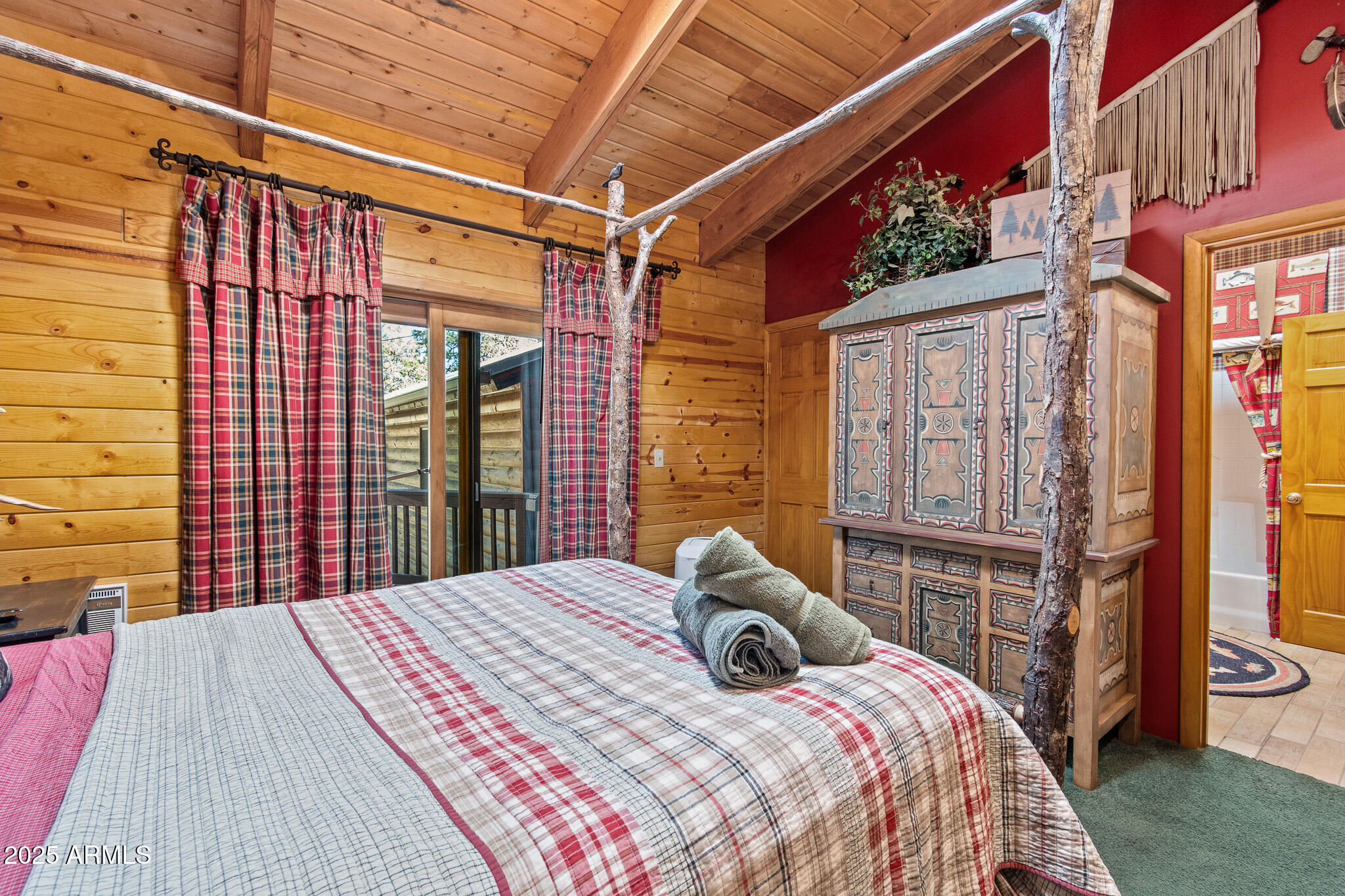 2948 Wildcat Trail Overgaard, AZ 85933 - Photo 11 of 38 a bedroom with a bed and a flat tv screen