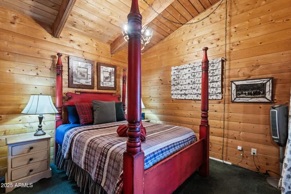 a bedroom with a bed and a flat tv screen