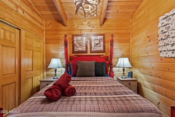 a bed sitting in a bedroom next to a lamp