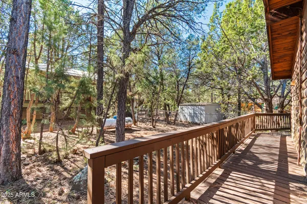 a view of a balcony with wooden fence and floor