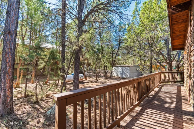 a view of a balcony with wooden fence and floor