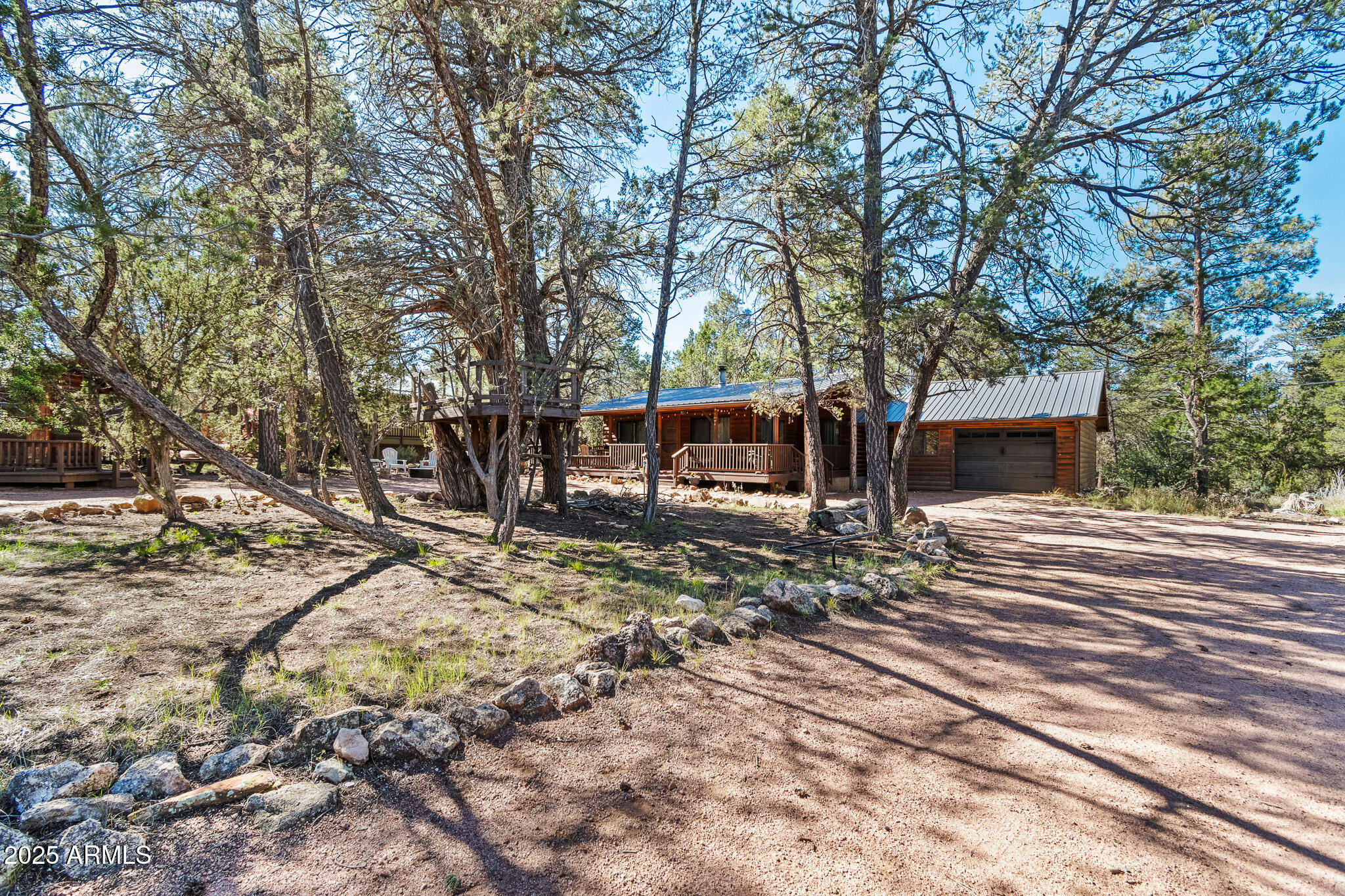 2948 Wildcat Trail Overgaard, AZ 85933 - Photo 29 of 38 a view of house with outdoor seating and covered with trees