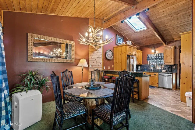 a view of a dining room with furniture a chandelier and wooden floor