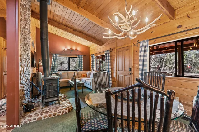 a view of a dining room with furniture and chandelier