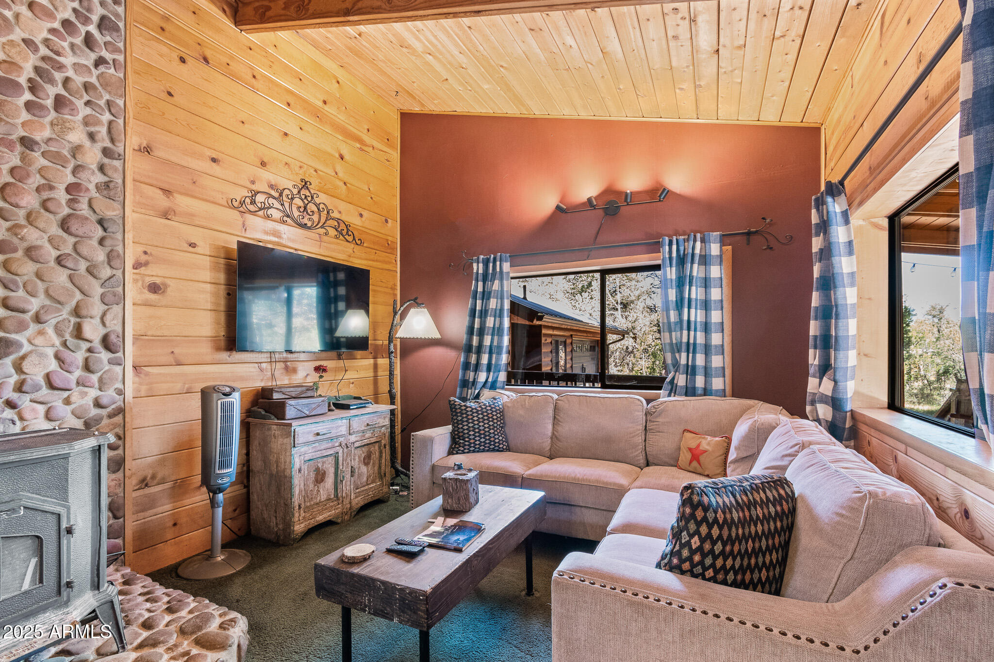 2948 Wildcat Trail Overgaard, AZ 85933 - Photo 5 of 38 a living room with furniture a fireplace and a table