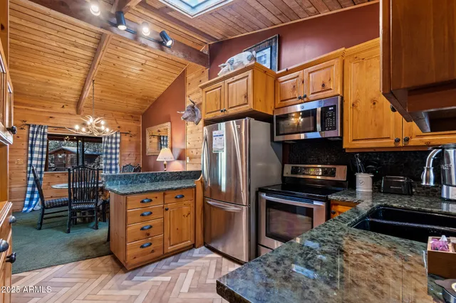 a kitchen with stainless steel appliances granite countertop a stove and a refrigerator