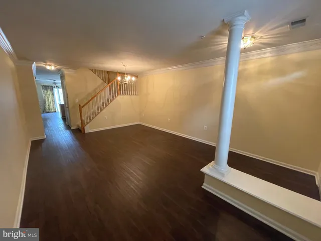a view of a room with wooden floor