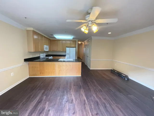 a view of a kitchen with a microwave and wooden floor