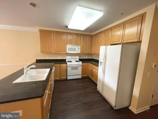 a kitchen with a refrigerator a sink and a stove