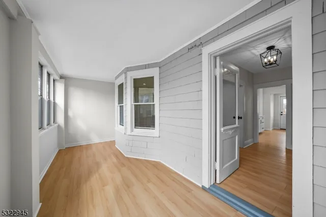 a view of hallway with wooden floor