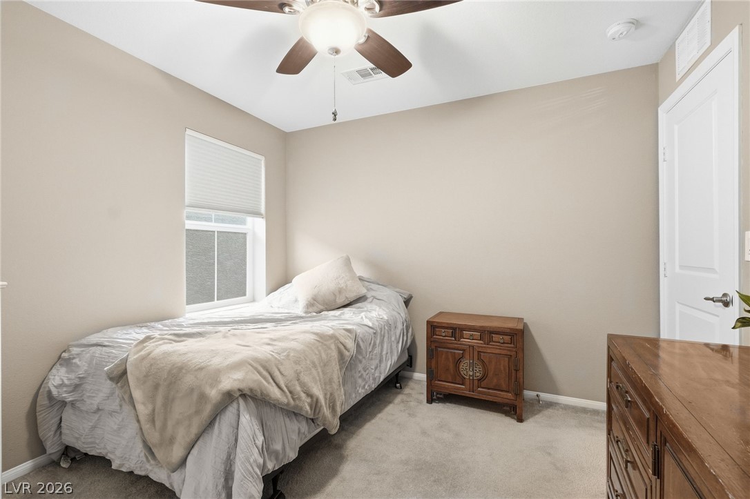 150 Fulgora Street Henderson, NV 89074 - Photo 53 of 92 Bedroom featuring light carpet and a ceiling fan