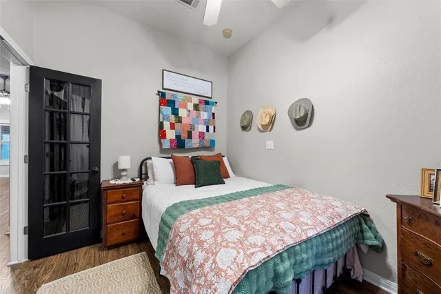 a bedroom with a bed and a painting on the wall