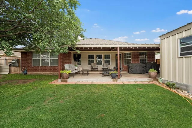 a view of a house with backyard porch and sitting area