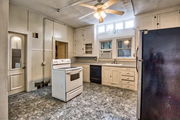 a kitchen with a stove oven and a refrigerator