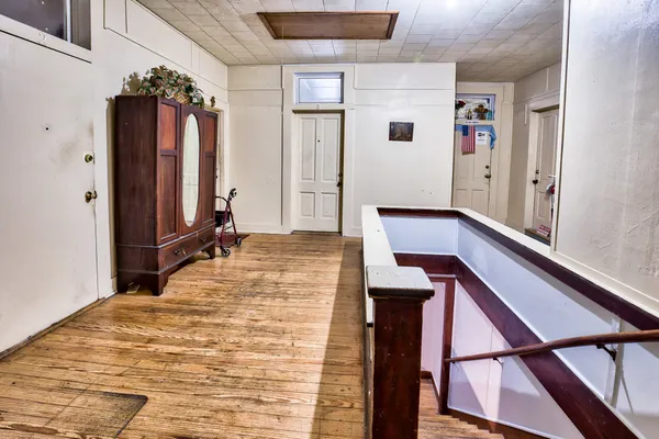 a bedroom with a bed and a large mirror