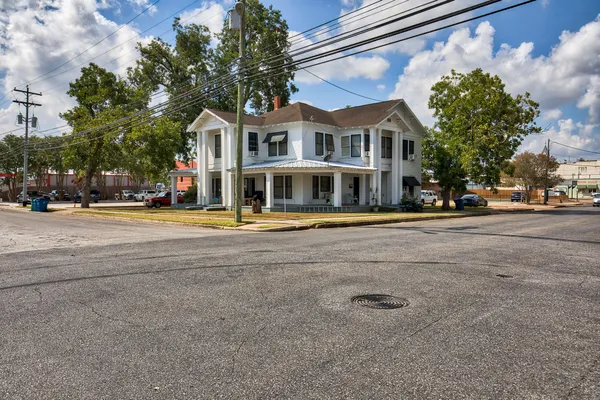 a row of palm trees in front of a building