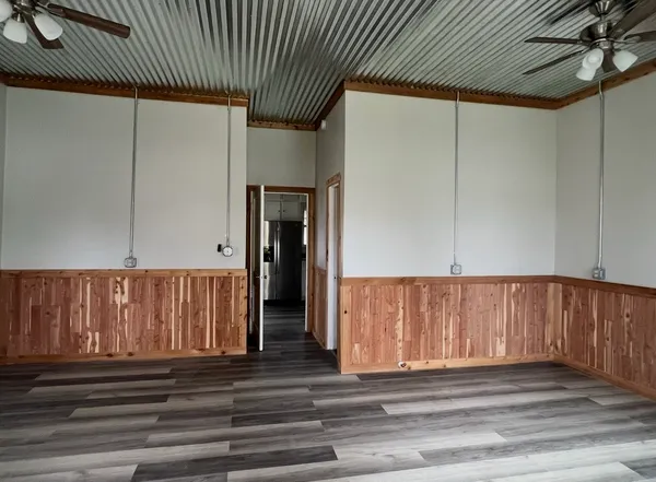 a front view of a building with street view and trees